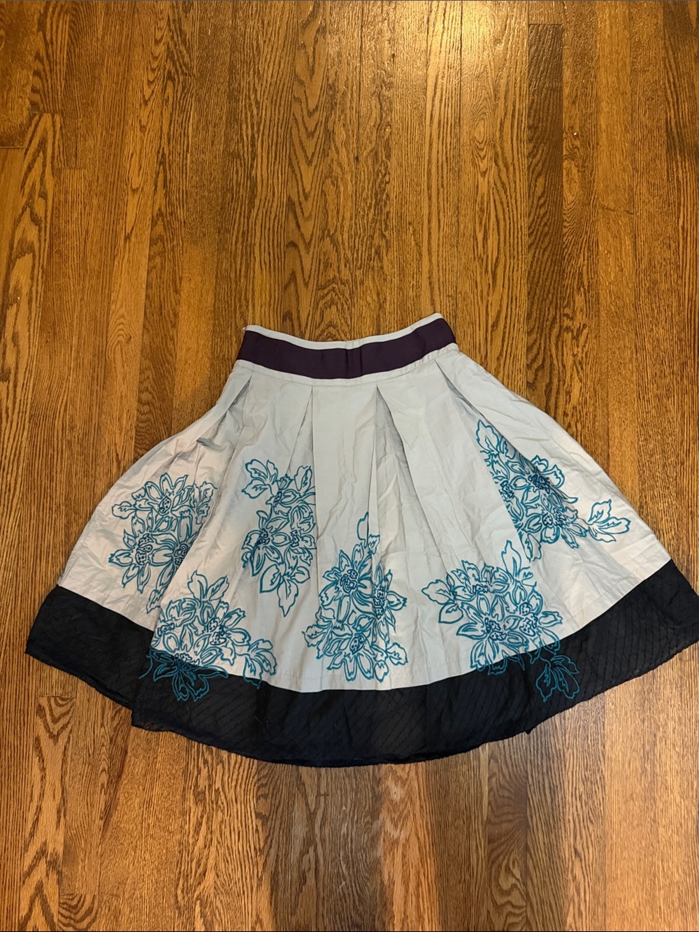 Anthropologie Light Gray Circle Skirt with Teal Floral Embroidery and Black Hem